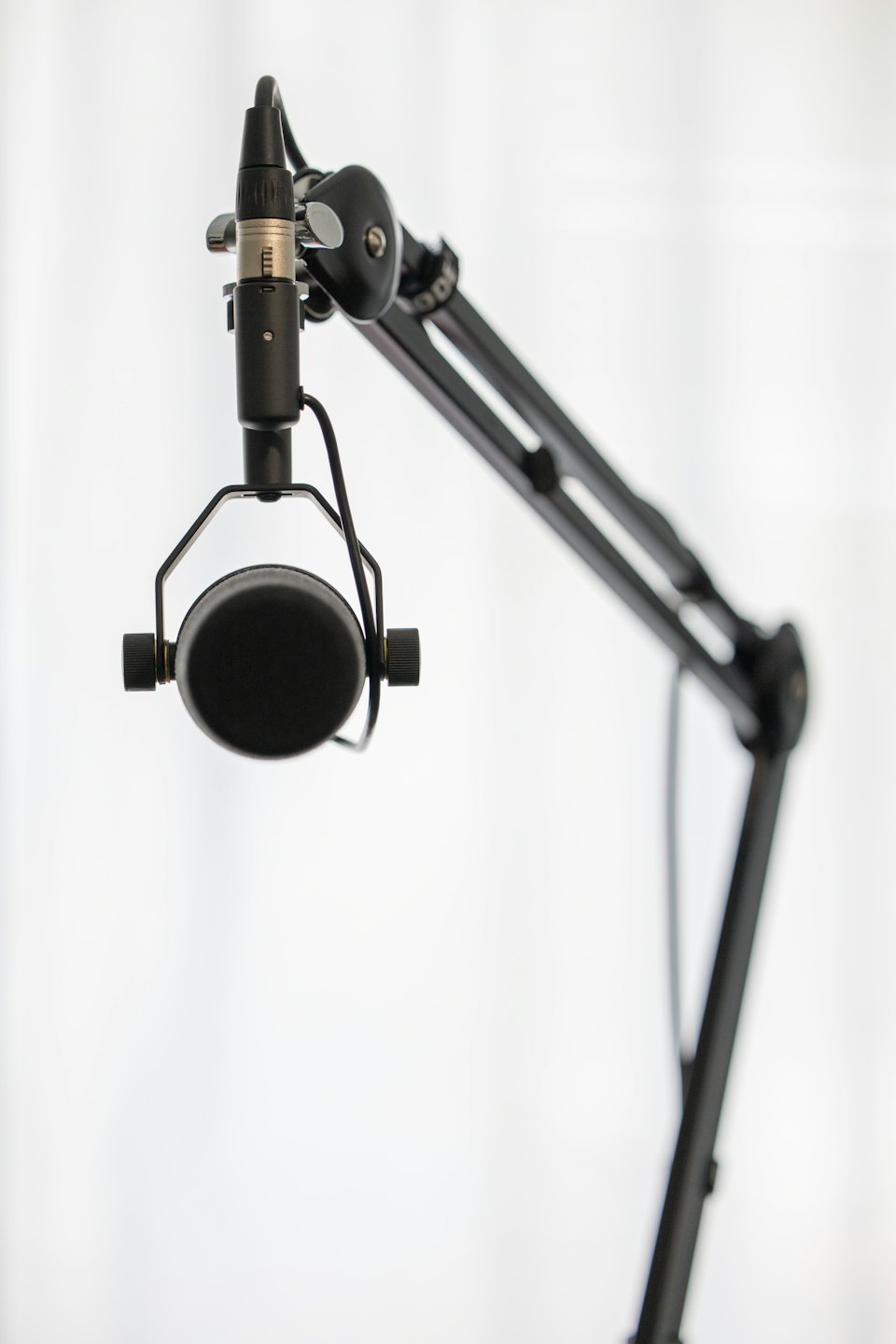 Condenser microphone suspended on a boom arm.